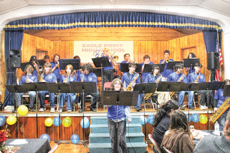 photo of the eagle point high school band on a raised stage at the grange hall.