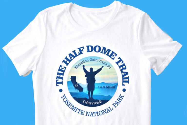 photo of an "I survived Half Dome" tee shirt. the shirt is white the graphic and lettering are shades of blue.