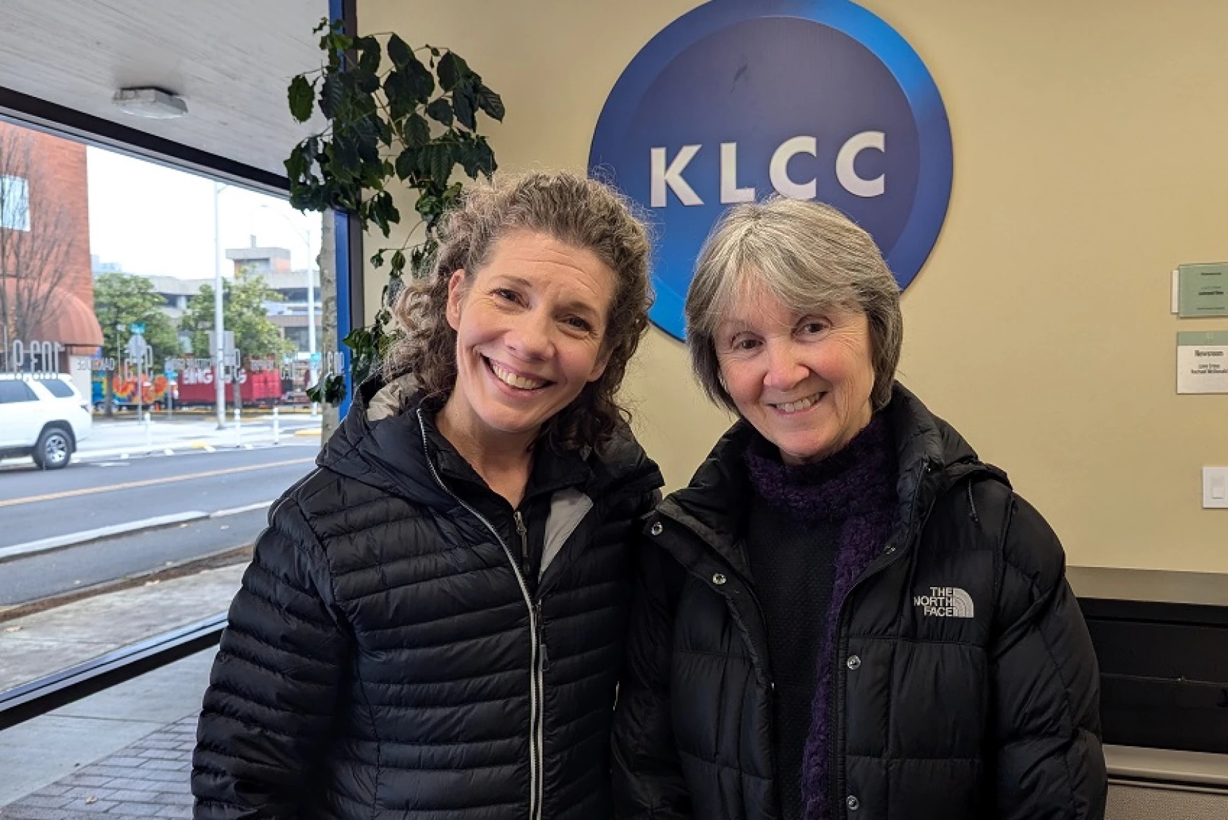 photo of two women in front of a KLCC sign.