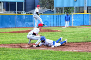 photo of a high school baseball player sliding into a base.