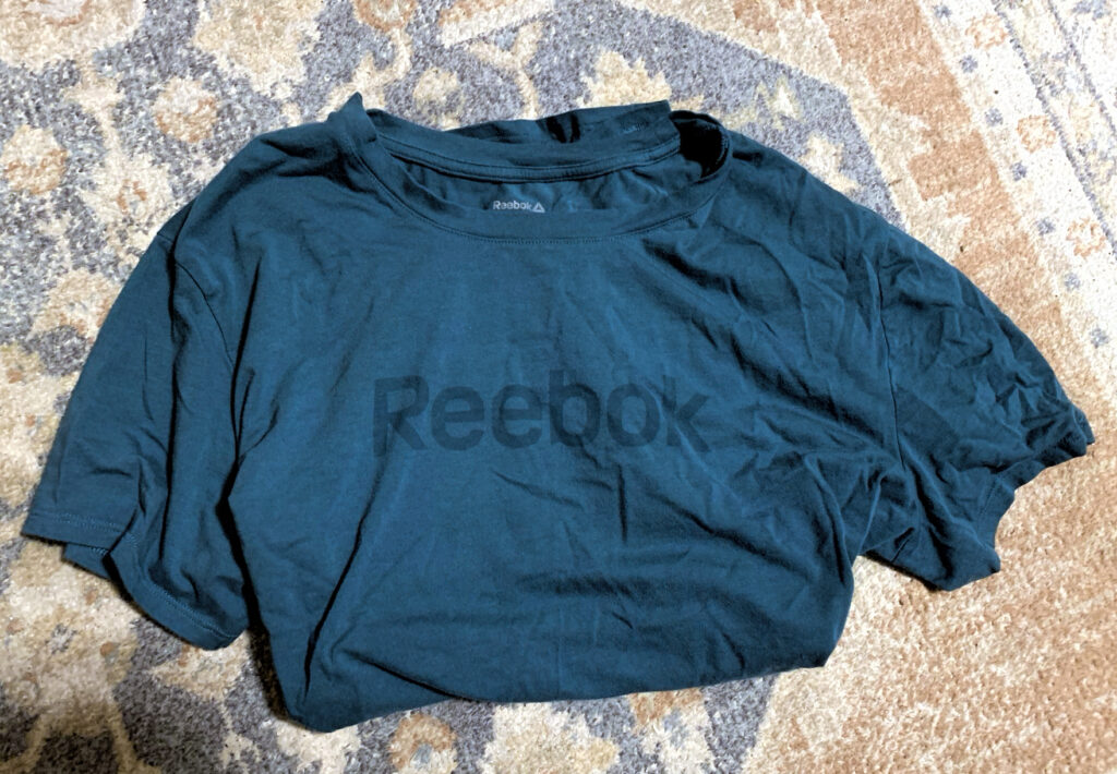 photo of a jewel-toned green reebok tee.