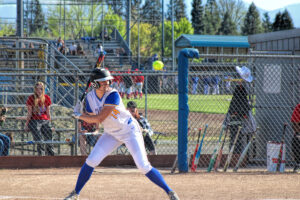 photo of a high school softball player at bat.