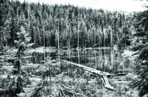 black and white photo of a mountain lake.