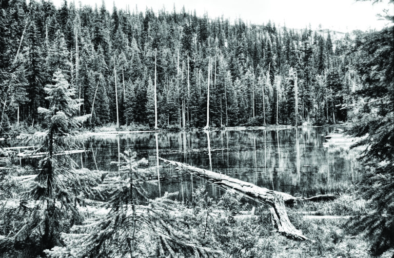 black and white photo of a mountain lake.