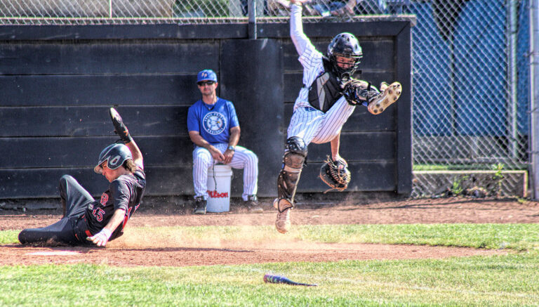 photo of home plate action at a high school baseball game.
