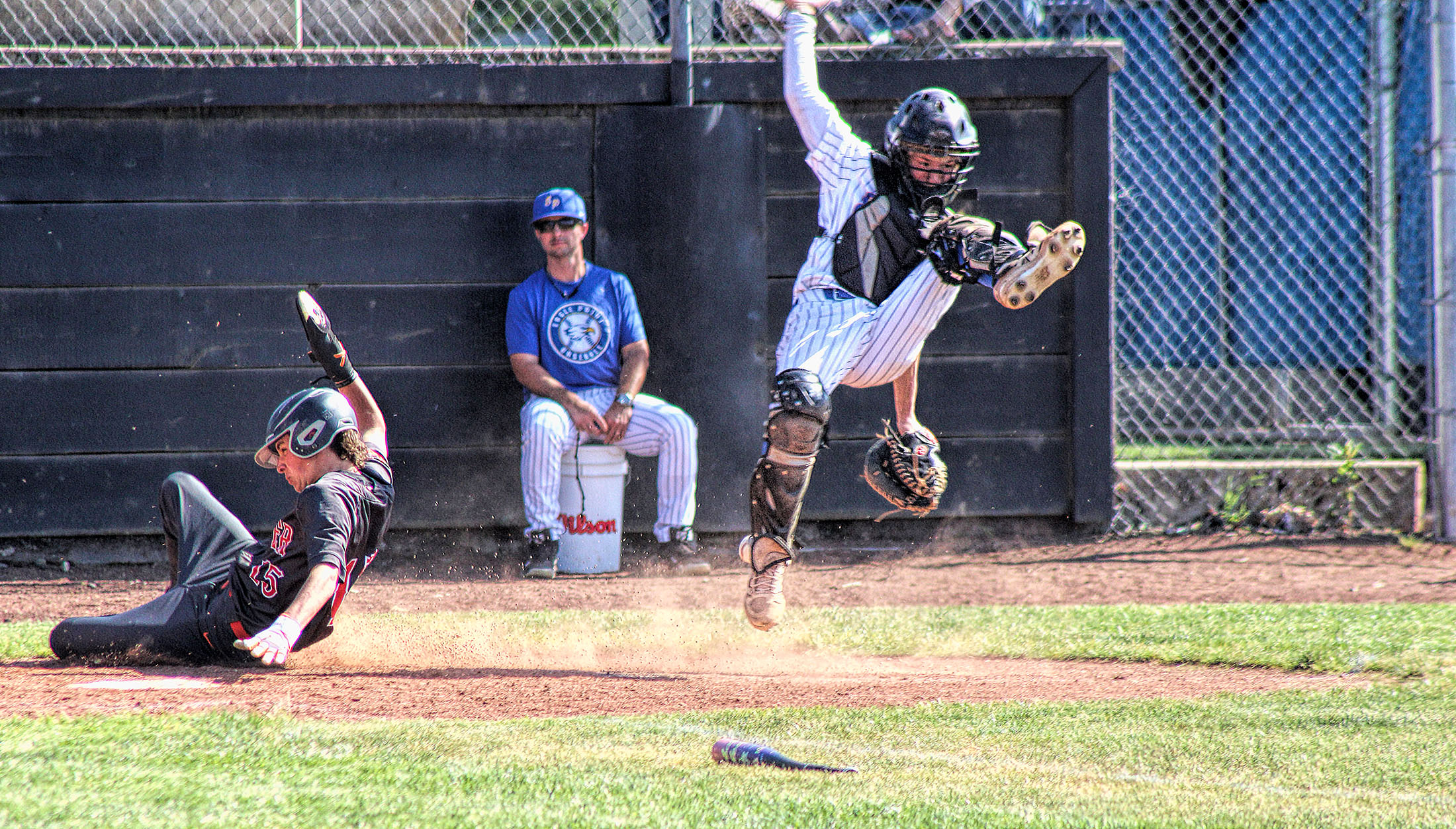 photo of home plate action at a high school baseball game.