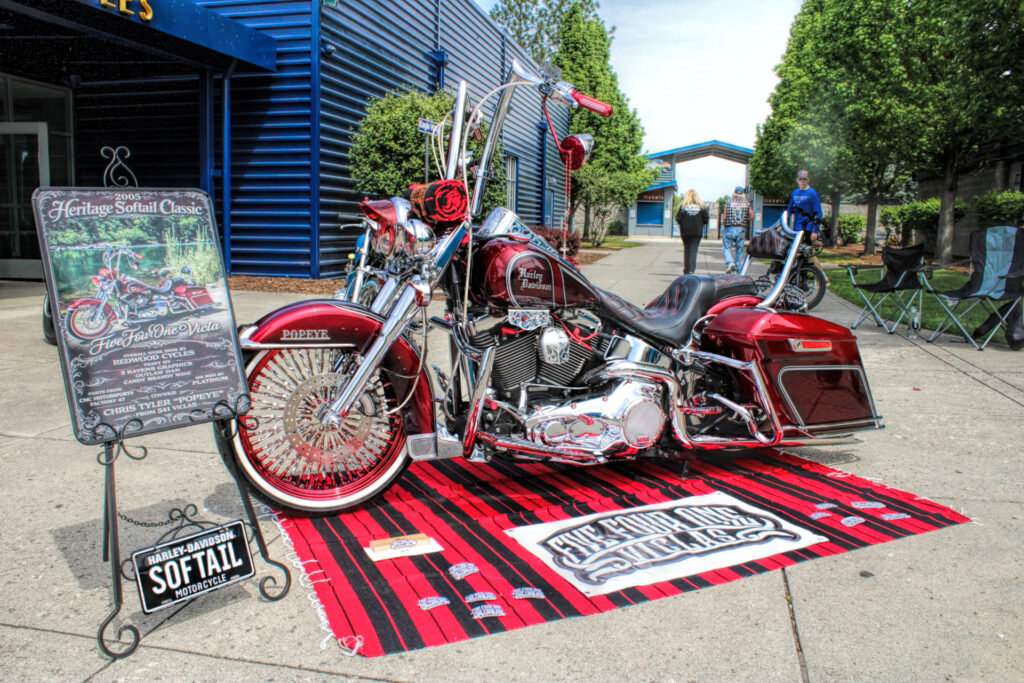 photo of a shiny red harley davidson motorcycle.