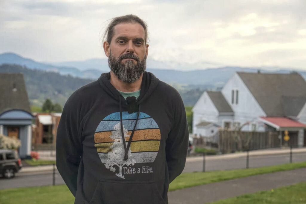 photo of a bearded man wearing a "take a hike" hoodie.