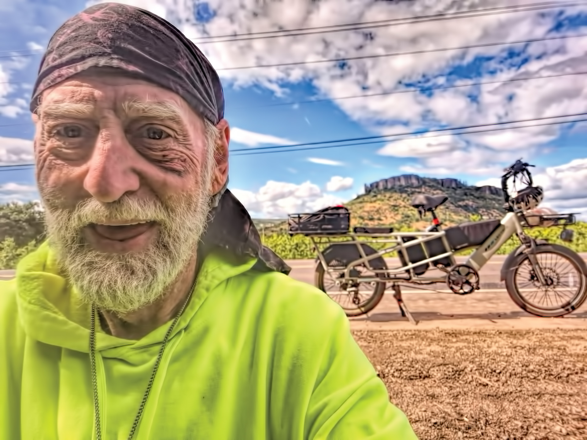 photo of wayne lee in front of Table Rock with his eBike behind him.