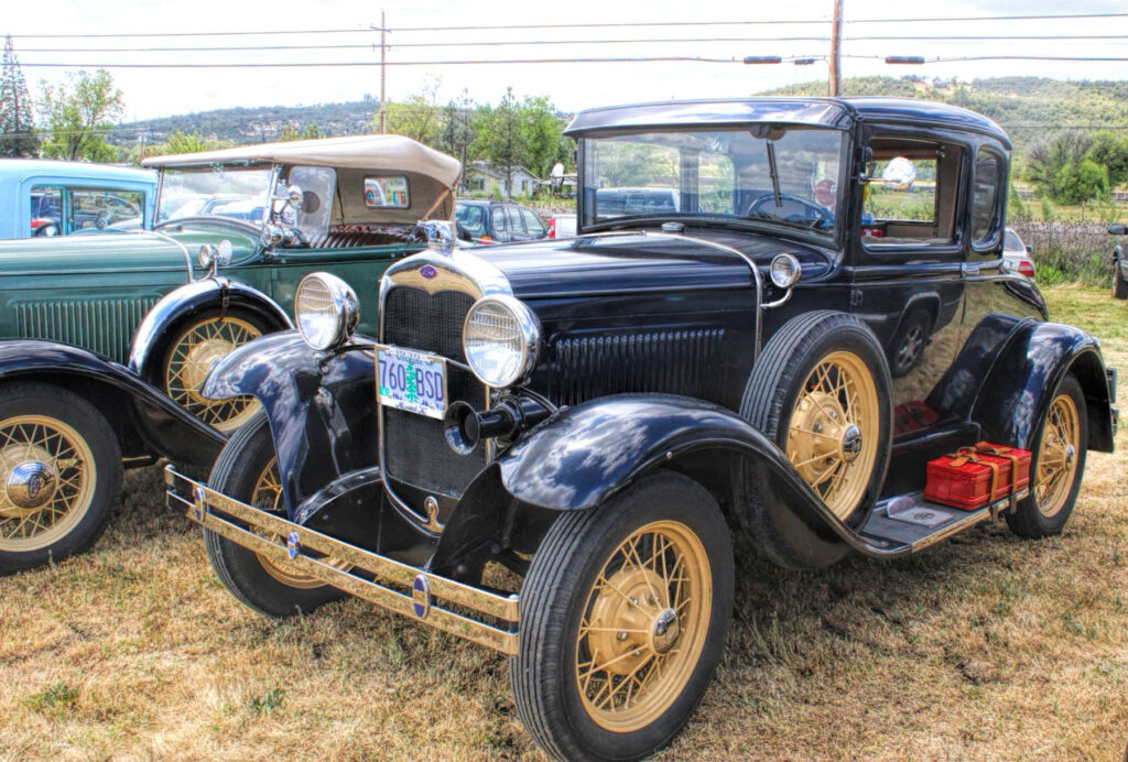 Photo of two ford model t cars.
