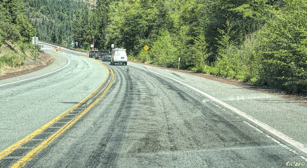 photo of many skid marks across the right lane and some onto the shoulder in front of a temporary stop light installed for bridge construction.