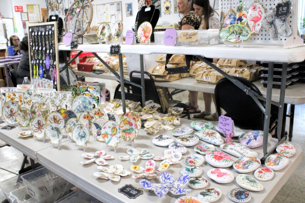 photo of a table of painted rocks at a craft fair.