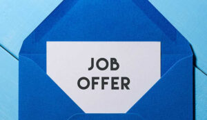 graphic of an envelope with a card inside reading "job offer"