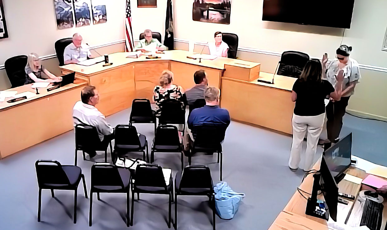 photo of a new commissioner being sworn in during a council meeting.