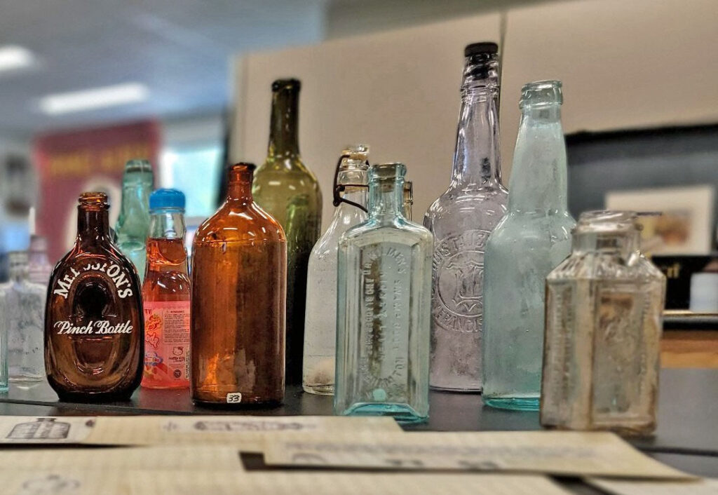 photo of several antique bottles made of different colors of glass.