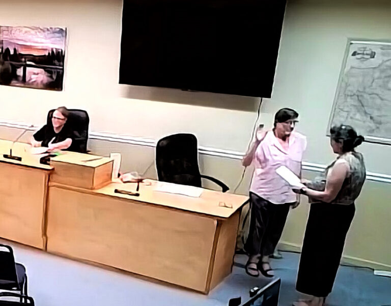 Zoom screen grab showing a female being sworn in as mayor.