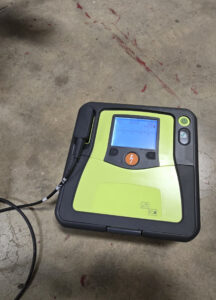 photo of a defibrillator on a concrete floor.