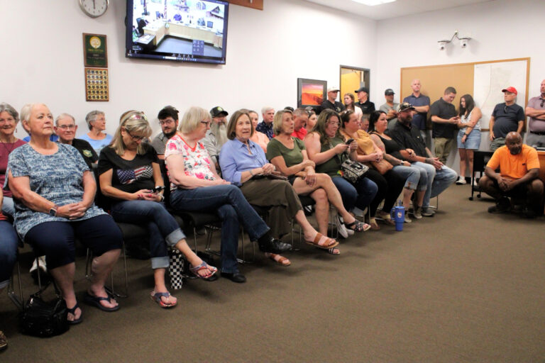 photo of citizens attending a standing room only council meeting.