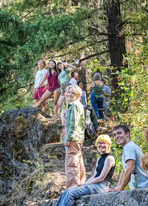 photo of a group of college students on a forested trail.