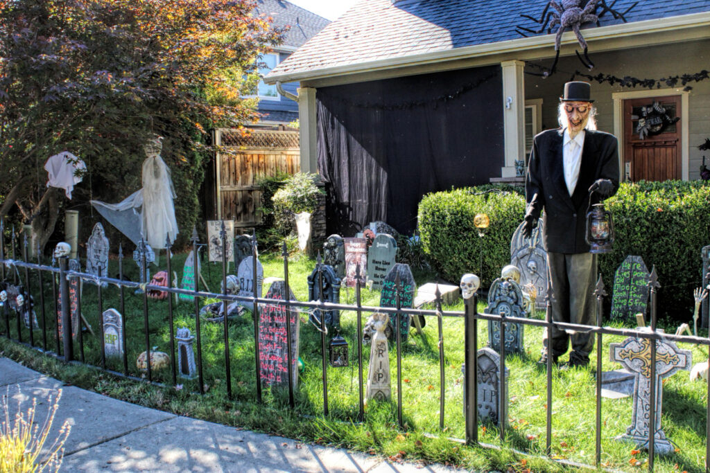 photo of a yard decorated for halloween with a graveyard and zombie gravedigger.