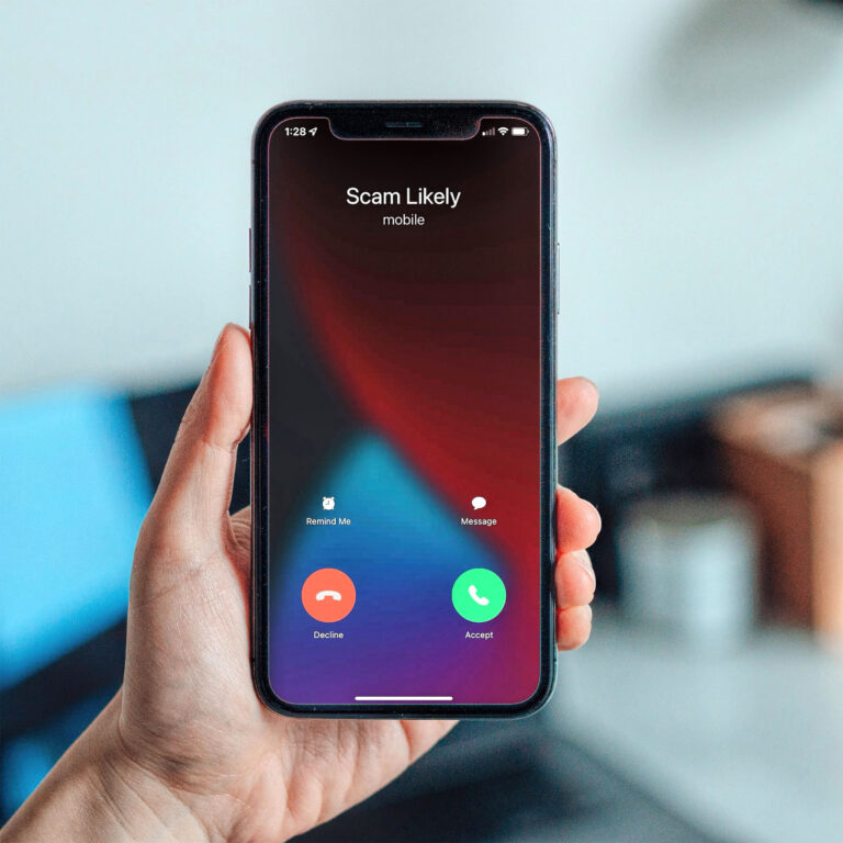 photo of a phone screen reading "Scam Likely"