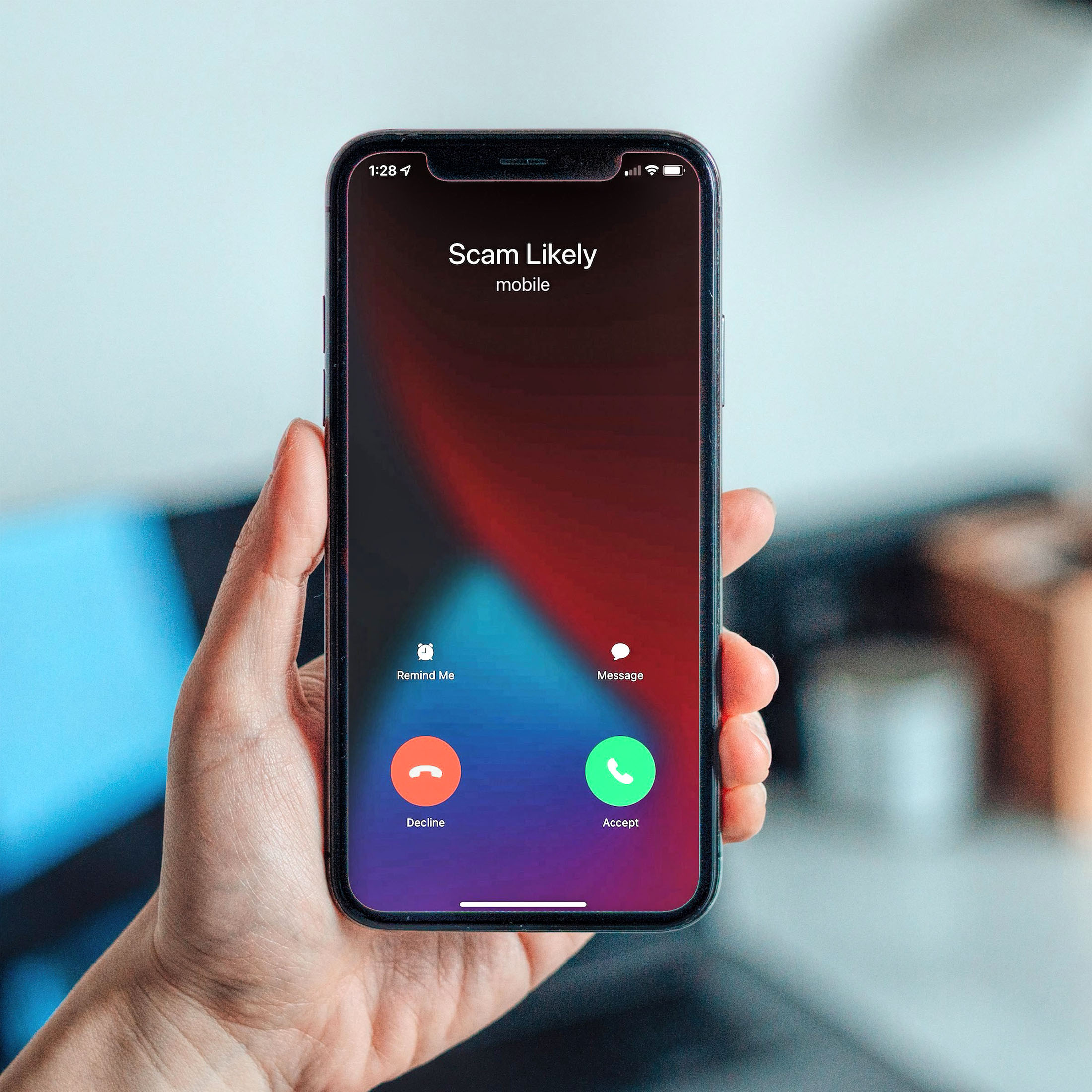 photo of a phone screen reading "Scam Likely"